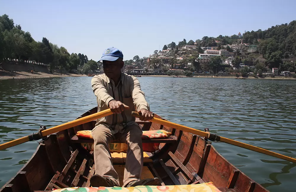 A boats-man surfing his boat in Naini Lake.. Pic: Shailesh Chauhan 