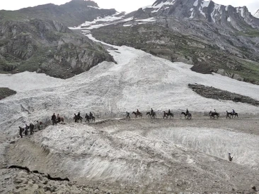 Pilgrims riding on horses on glacier to reach Amarnath