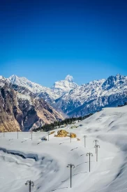 Ski slopes and artificial lake (frozen) at Auli. Mt. Nanda Devi in the centre.