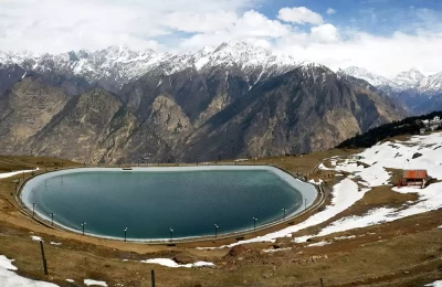 A beautiful view of artificial lake at Auli and snow capped peaks in the backdrop.