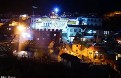Badrinath temple at night with steam rising from Tapt kund