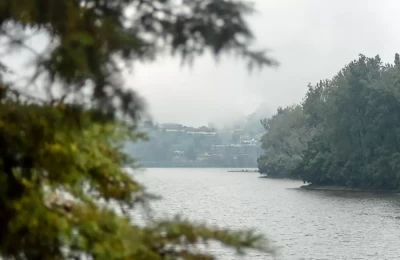 Bhimtal lake on a foggy evening during the monsoon season.