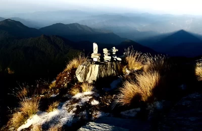 Morning rays falling on the stone-heaps made by travellers on Chandrashila top near Tungnath temple.