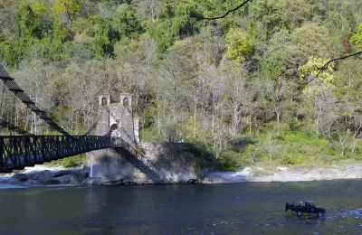 This wide picture is capturing the old era bridge as well as modern symbol of Jim Corbett National Park, the open 4 x 4 Jeep. Both these elements of this picture are soul of this Jungle by Human.
