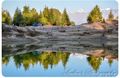 Early Morning View Of Deoria Tal with Camps Beside and Mighty Himalayan Peaks in the background.