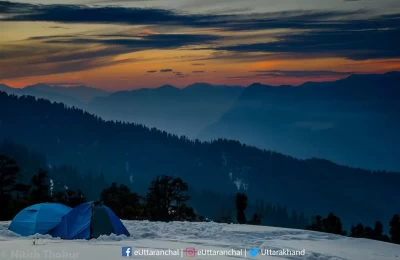 It's a winter time and getting a flat land without snow is tough here. Trekkers enjoying the warm shed in their camps on the way of Kedarkantha Trek.