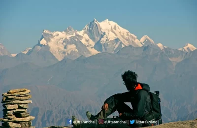 Sandy, our team very experienced member in the field of trekking enjoying a peaceful time in the tranquility of Himalayas. En route Kedarkantha Trek 