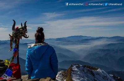The Trishul of lord Shiva or shri Kedarkantha and a trekkers overlooking the uncountable range of mountains from Kedarkantha summit & trek