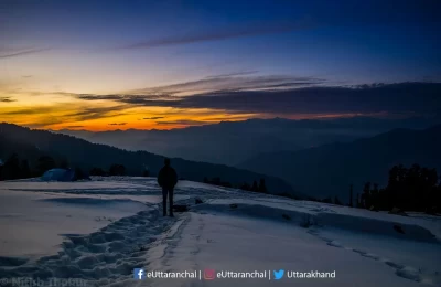 Crimson hues of setting sun. View from the route of Kedarkantha Trek.