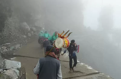 A devotee with trishul and damru in his hand coming back from Kedarnath temple towards Gauri kund.