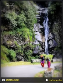 A beautiful water fall on the side of road in Thal Munsiyari, Pithoragarh & local women carrying fodder for their cattle.  