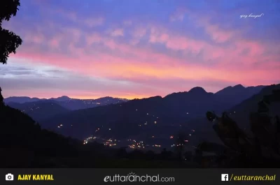 A distance view of a small town in Munsiyari, Pithoragarh with beautiful clouds over the mountains.