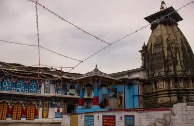 the Picture depicts the Ukimath temples full view from the entry side. The sky is full of clouds