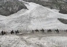 Pilgrims riding on horses on glacier to reach Amarnath