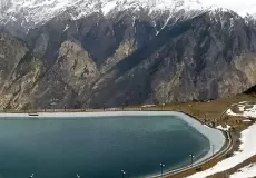 A beautiful view of artificial lake at Auli and snow capped peaks in the backdrop.